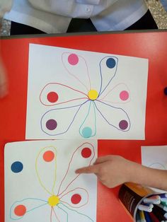 someone is doing something with colored circles on paper