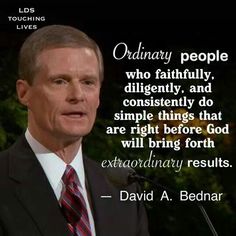 a man wearing a suit and tie standing in front of a microphone with a quote on it