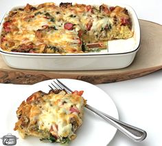 a casserole dish on a plate with a fork next to the casserole