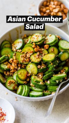 a bowl filled with cucumbers and nuts next to two bowls of other food