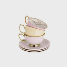 three tea cups and saucers stacked on top of each other, with one cup in the middle