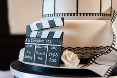 a close up of a cake with a movie clapper on it's side