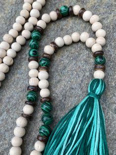 Natural wooden beads (8mm) malachite gemstone beads coconut beads multicolored, 100% cotton tassel This necklace measure 36 inches. Total hanging length from nape of neck to end of tassel is 21.5 inches. the beads & tassel at the end of the necklace measures 3.5 inches. The tassel is 2.5 inches Other styles available 😀😀 Please take a few moments to browse through my shop. I have a large selection of unique belt bucks, leather belt straps & jewelry available. https://www.etsy.com/listin Bohemian Wooden Beads Tassel Necklace Gift, Bohemian Tassel Necklace With Wooden Beads For Gift, Bohemian Natural Jewelry With 8mm Beads, Bohemian Natural 8mm Bead Jewelry, Natural Bohemian Jewelry With 8mm Beads, Beaded Tassel Necklace, Mens Necklace, Wood Bead Necklace, Necklace Long