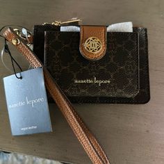 This Great Card Case Features An Exterior Cc Slip Pocket And A Zip Pocket. Detachable Wrist Strap. Unsnap The Tab And Unfold To Reveal Two More Cc Slip Pockets And A Clear Id Window. Slim Design. Measures Approx. 3.75” X 5”. Luxury Coach Wallet On Chain In Rectangular Shape, Brown Rectangular Card Holder With Zipper Pouch, Nanette Lepore Handbag, Chocolate Logo, Nanette Lepore, Logo Color, Slim Design, Wrist Strap, Card Case