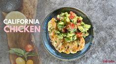 a blue plate topped with chicken covered in guacamole and tomatoes next to a cutting board