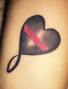 a heart tattoo with a red line across it