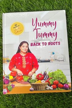 the book yummy tummy back to roots is laying in the grass