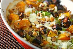 a white bowl filled with food on top of a table