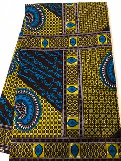 a close up of a tie with blue and yellow designs on it's side