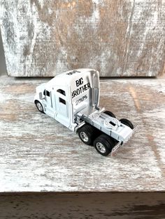 a toy truck is sitting on a wooden table