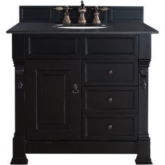 a black bathroom vanity with two sinks