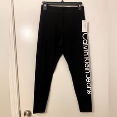 Calvin Klein Leggings. Size Small. Black With White Letters Down The Leg. Brand New. Casual Stretch Calvin Klein Bottoms, Trendy Fitted Calvin Klein Bottoms, Calvin Klein Stretch Casual Bottoms, Calvin Klein Casual Stretch Bottoms, Calvin Klein Stretch Bottoms, Calvin Klein Stretch Elastane Bottoms, Calvin Klein Stretch Casual Pants, Calvin Klein Stretch Bottoms For Spring, Spring Stretch Bottoms By Calvin Klein