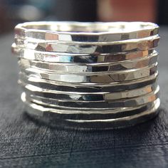 "Sleek yet slightly rustic bohemian, these trendy Sterling Silver stackable rings will be made to order for you as a set of 10 bands. Created entirely by me in my jewelry studio, these awesome skinny rings are completely hand forged, hammered for texture, tumbled and polished to a high shine. Each ring is approximately 1mm wide, so 10 worn together measure about 10mm wide. {LISTING FEATURES} ~ Sterling silver ring ~ Very skinny rings ~ Stackable with each other ~ Shiny silver finish ~ Hammered t Sterling Silver Stackable Rings, Rings Stacking, Ring Sets Boho, Multiple Rings, Stackable Rings Silver, Sterling Silver Stacking Rings, Stacking Ring Set, Hammered Rings, Silver Stacking Rings