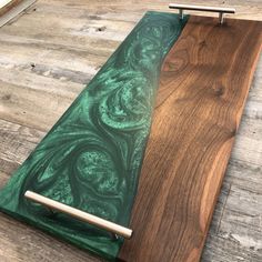 a wooden table with green and brown marble inlays on the top, next to a pen holder