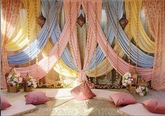 a decorated stage with pink and blue drapes