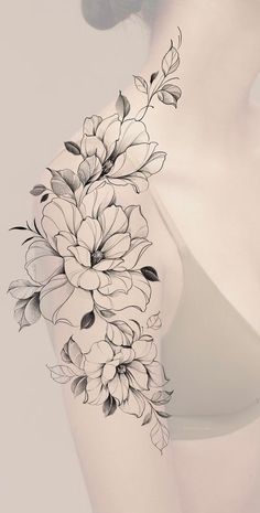 a woman's arm with flowers on it and the back of her body in black ink