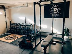 a home gym with benches and weights