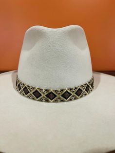 **Please read in full before purchasing** Colors: Black, Brown, Beige Leather Ends: Black Leather Ties: Black Pattern: Rattlesnake Width: 7/8" Should fit most hats size 6.75 or larger.  Please message me for a custom size. I make all my hatbands on a loom using quality delica seed beads.  I design my hatbands in a wide variety of colors and patterns, and I do the leatherwork on the ends myself, focusing on quality.  Custom options available. Please be careful not to damage your purchase when opening your package.  I carefully hand stitch or bead all my pieces in the state of Indiana.  They are handcrafted with the utmost attention to detail using unique color combinations and patterns. Perfect for gift giving! Unique Color Combinations, Cow Boy, I Design, Hat Band, Be Careful, Brown Beige, Black Pattern, Hat Sizes, Leather Working