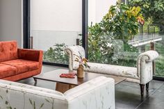 a living room with two couches and a coffee table in front of a large window