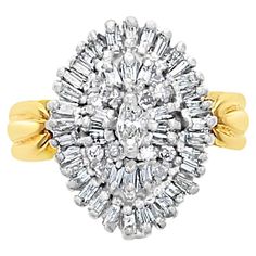 a diamond cluster ring set in yellow gold and white gold, with baguets