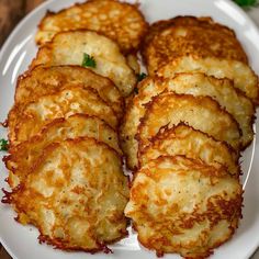 some fried food on a white plate with parsley