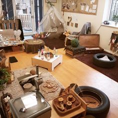 a living room filled with furniture and lots of clutter on top of a hard wood floor