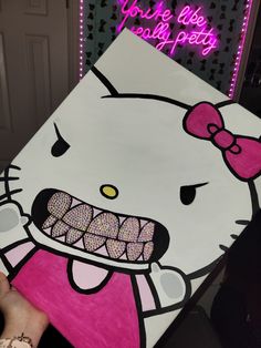 a hello kitty birthday party sign with the word hello kitty on it and a pink bow