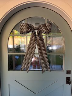 a door with a large bow hanging on it