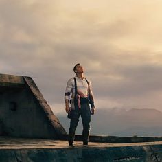 a man standing on top of a cement ramp