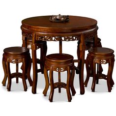 a wooden table with four stools around it