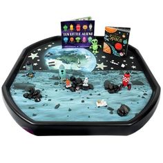 a black tray with some books and toys on it