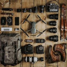 the contents of a camera bag laid out on a wooden floor