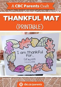 a child holding up a printable thanksgiving card with the words, i am grateful for