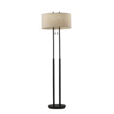 a black floor lamp with a beige shade on it's side and a white background