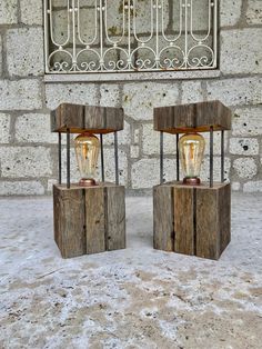 two old fashioned lightbulbs sitting side by side in front of a brick wall