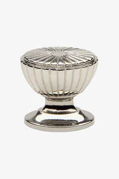 a silver plate with a decorative design on the top and bottom, sitting on a white surface