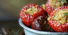 stuffed red peppers in a metal bowl on a table