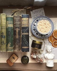 an assortment of old books, orange slices and other items sit on a book shelf