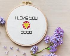 a cross - stitch pattern with the words i love you 30000 on it next to lavender flowers