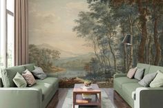 a living room filled with furniture and a large painting on the wall behind two couches