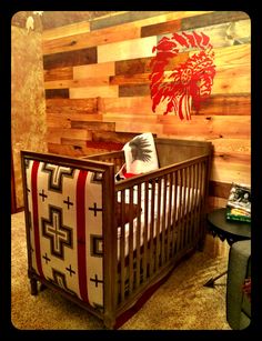 a baby crib in front of a wooden wall