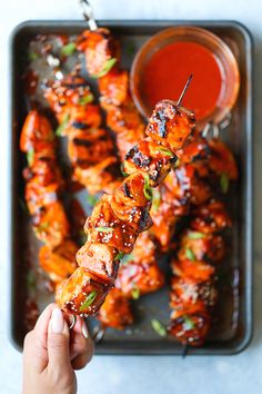 chicken skewers on a tray with dipping sauce