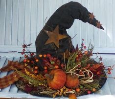 a scarecrow's hat sitting on top of a table filled with autumn decorations