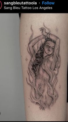 a woman's arm with a black and white tattoo design on the left thigh