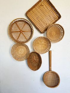 wicker baskets and spoons hanging on the wall