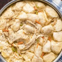 a pot filled with chicken and dumplings on top of a table