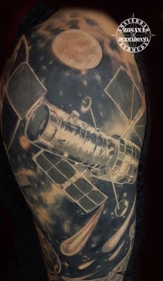 a man with a tattoo on his arm that has an image of a space shuttle in it