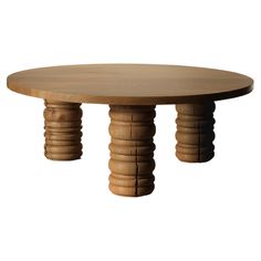 a round wooden table with columns on the top