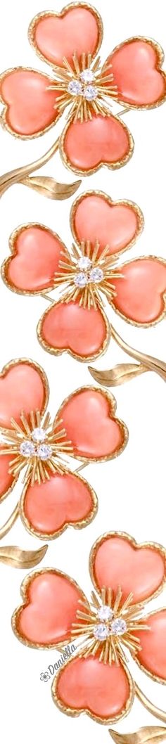 four pink flowers with diamonds in the center and gold trimmings on each side