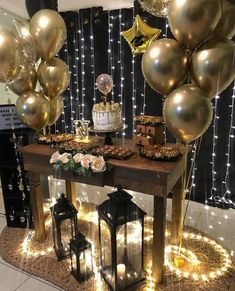 a table topped with lots of gold balloons